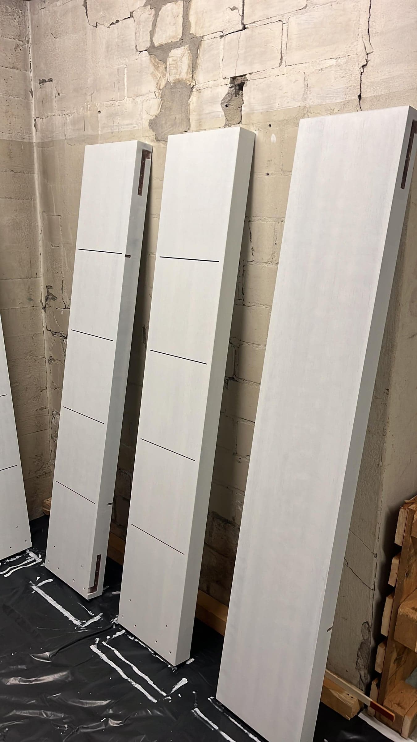 Floor-to-ceiling fitted cabinet with matte white fronts
